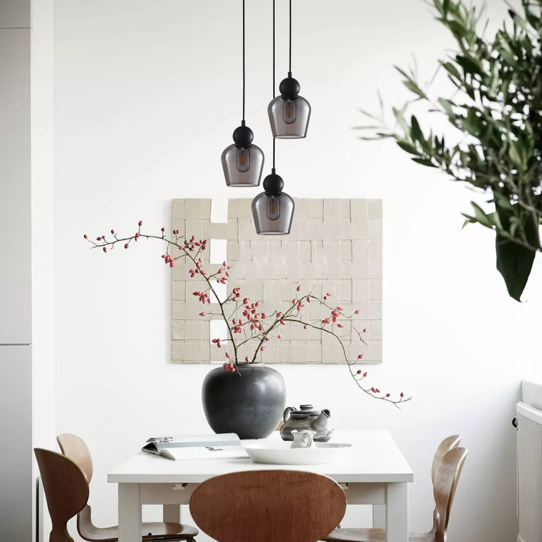3 Light Chapman black pendant over a white dining table