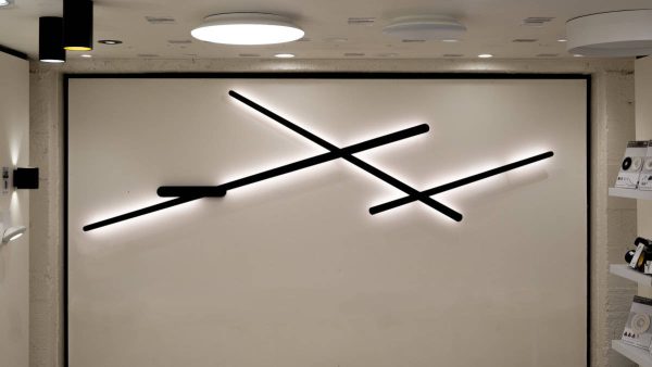 image showing bay 3 from our showroom, the back wall light is lit by a large song wall light and the lower ceiling includes led ceiling buttons and surface mount downlights