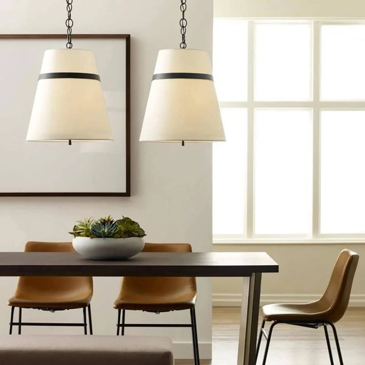 Cordtlandt black pendants with linen shades over a dining table