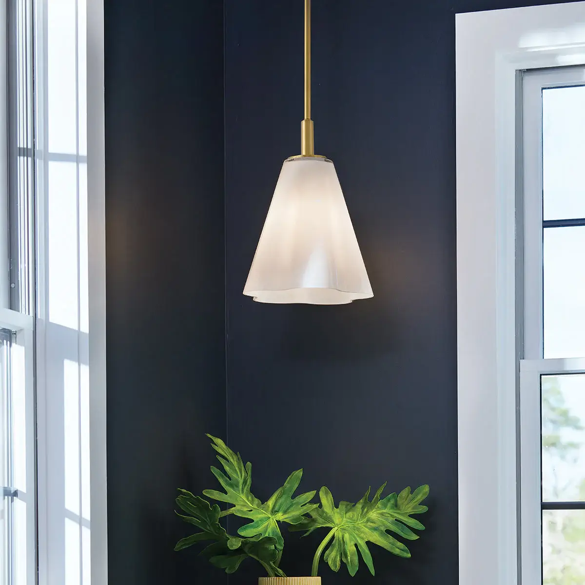 Honey Brass Pendant hanging in the corner of a room